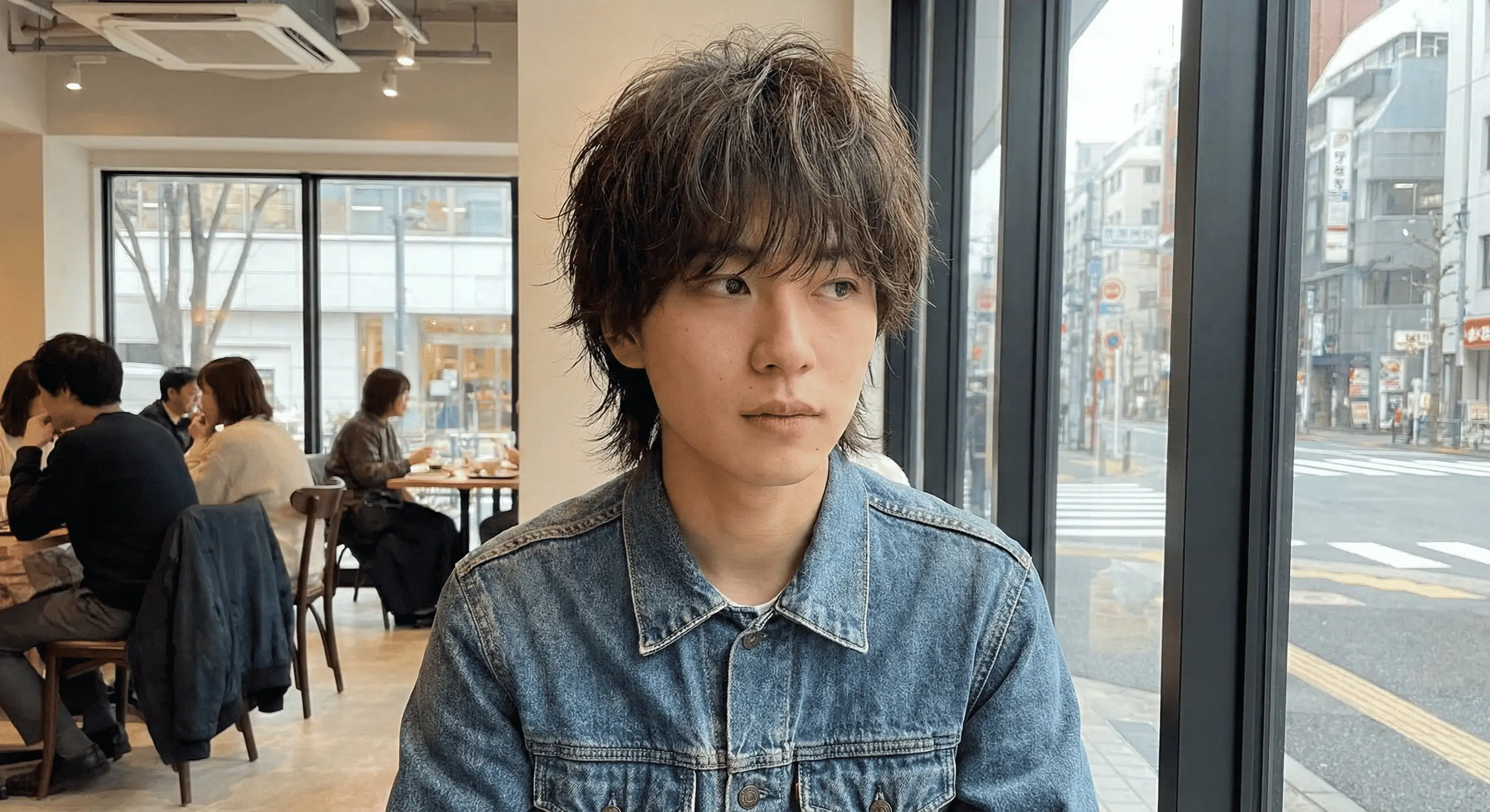 Asian man on a cafe styling a Japanese Wolf Cut